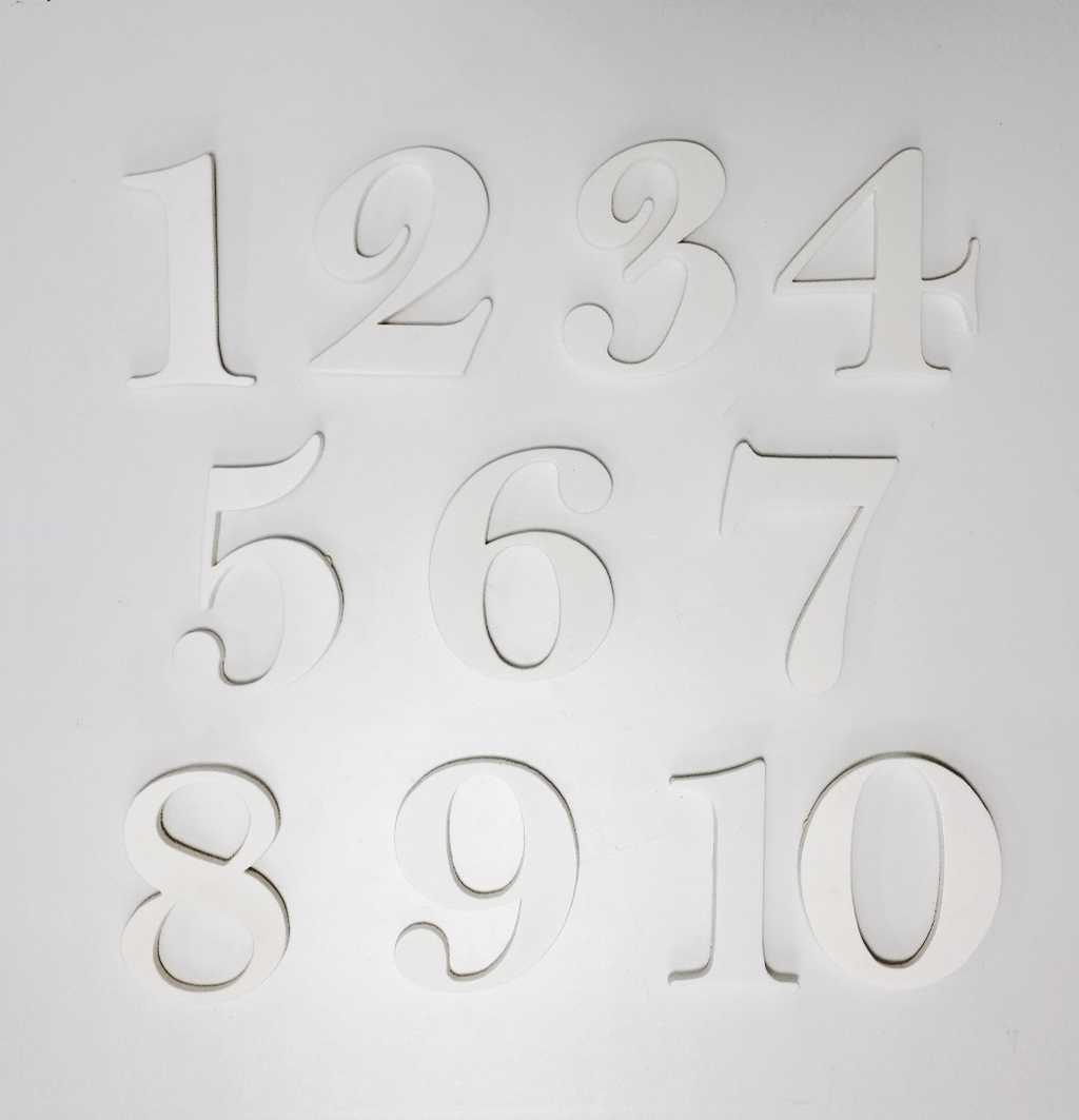 Tyylikkäät valkoiset muotoonleikatut pöytänumerot ovat paksua muovia